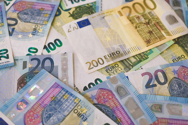 Euro banknotes and a payment card representing currency and payment options in Albania